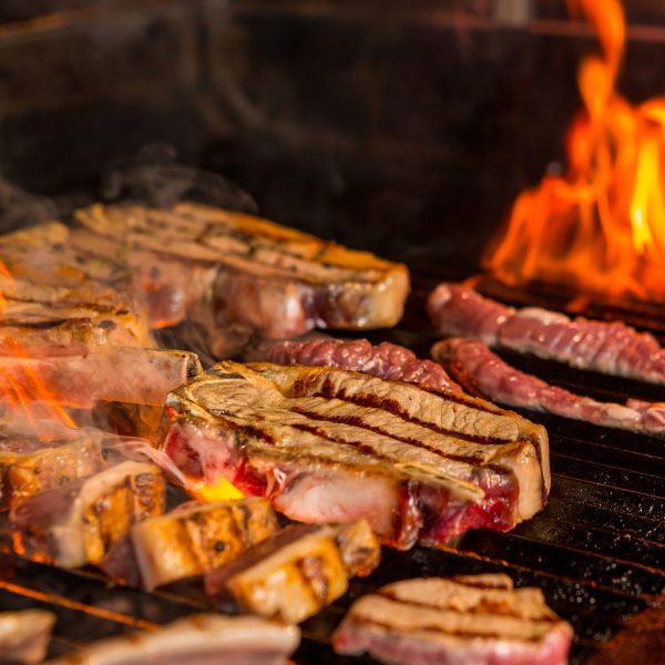 half-grilled-half-ready-raw-steaks-grill